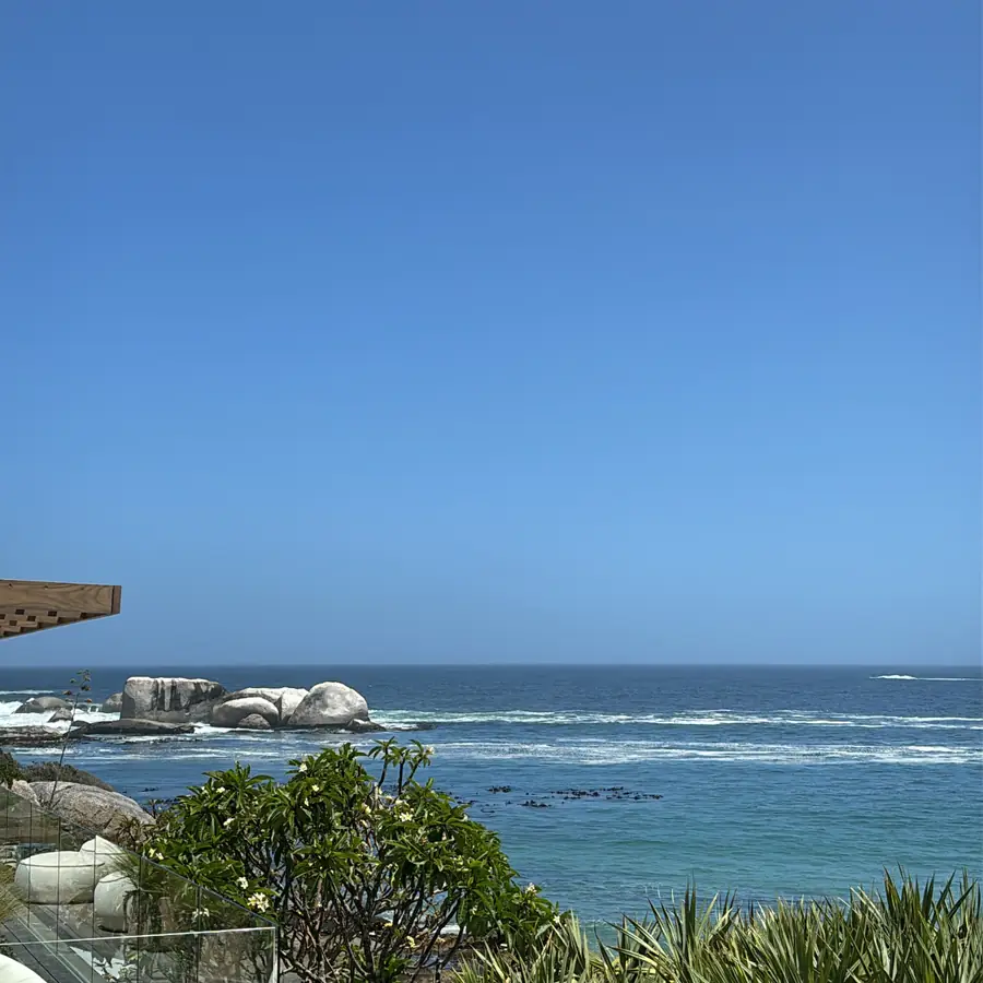 Sea-facing terrace with white lounge furniture above the Atlantic